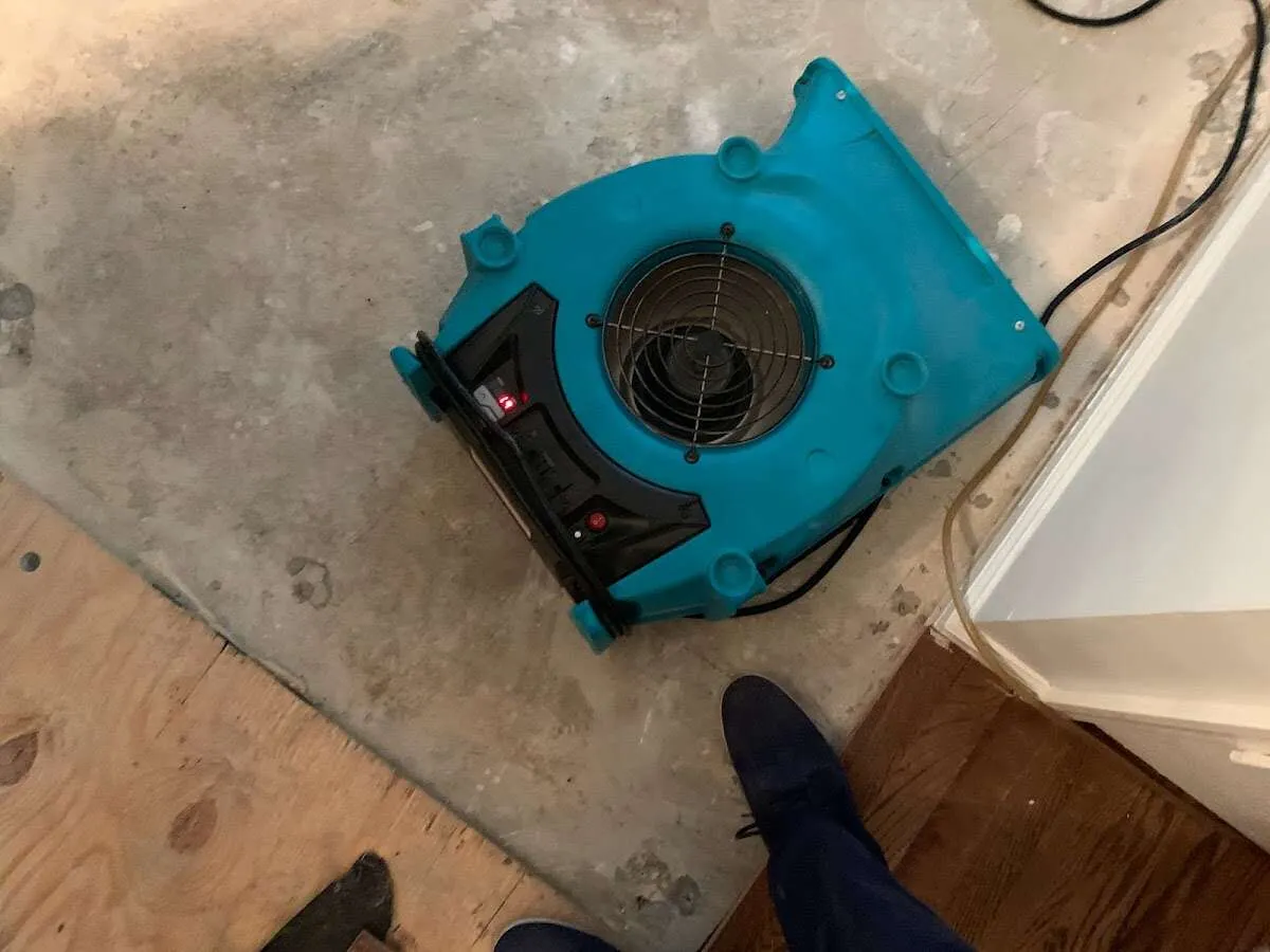 Air mover drying subfloor during Commercial Water Damage Restoration in Ponca City